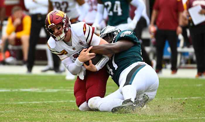 Philadelphia Eagles defensive tackle Javon Hargrave (97) tackles Washington Commanders quarterback Carson Wentz