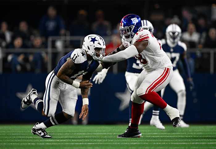 New York Giants offensive tackle Andrew Thomas puts his hands out to try to block Dallas Cowboys linebacker Micah Parsons