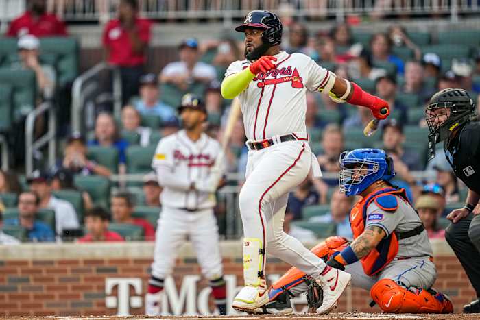 Aug 22, 2023; Cumberland, Georgia, USA; Atlanta Braves designated hitter Marcell Ozuna (20) follows through after hitting a single against the New York Mets during the second inning at Truist Park.