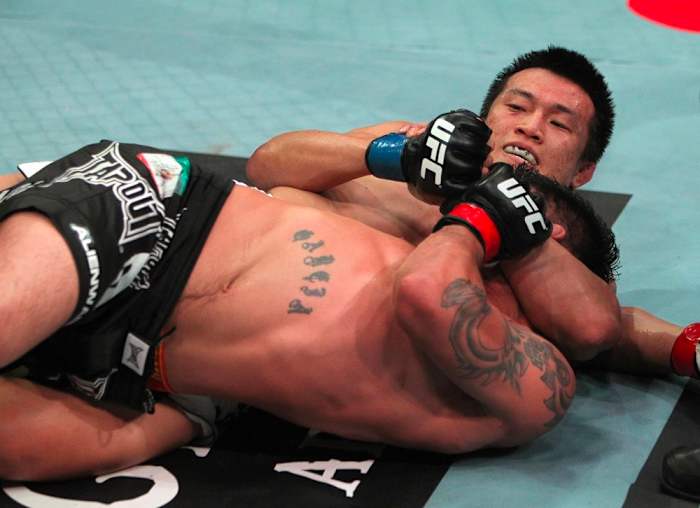 Chan Sung Jung finishes a Twister submission.