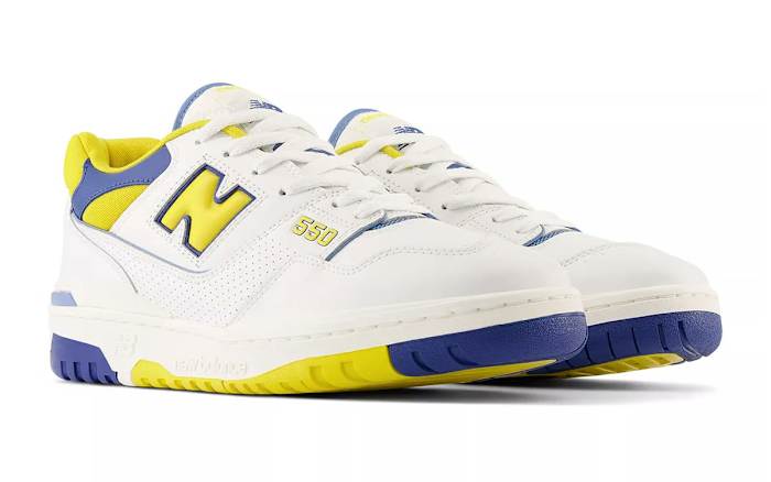 Side view of white, yellow, and blue New Balance sneakers.