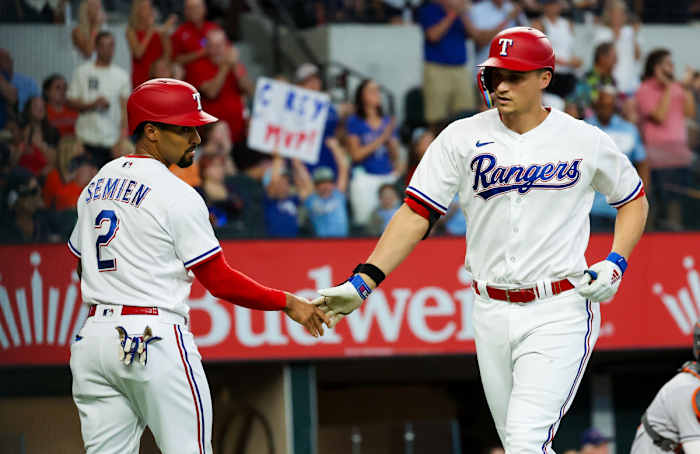 Texas Rangers shortstop Corey Seager, celebrates with Texas Rangers second baseman Marcus Semien after hitting a two-run home run in the first inning against the Houston Astros at Globe Life Field. Seager homered again in the fifth.
