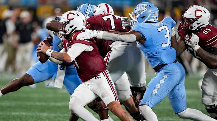 North Carolina's Kaimon Rucker and Amari Gainer sack South Carolina QB Spencer Rattler.