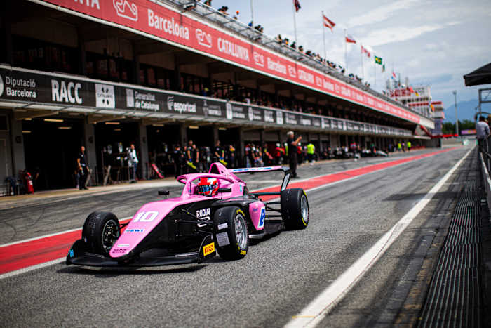 Abbi Pulling drives in a pink racecar