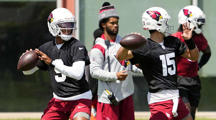 Cardinals quarterbacks Joshua Dobbs and Clayton Tune throw passes during a practice as Kyler Murray looks on.