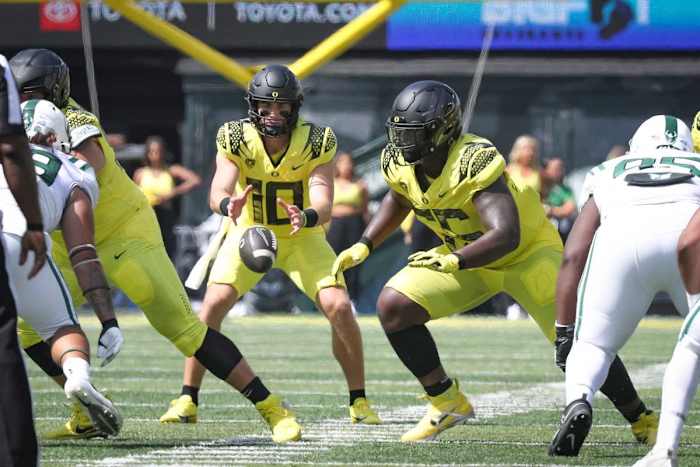 Oregon Ducks quarterback Bo Nix fields a snap against the Portland State Vikings.