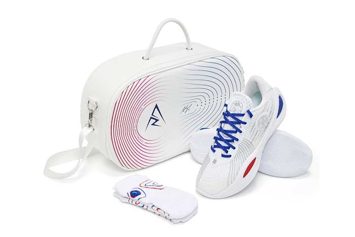 Side view of Austin Reaves' white, blue, and red sneakers.