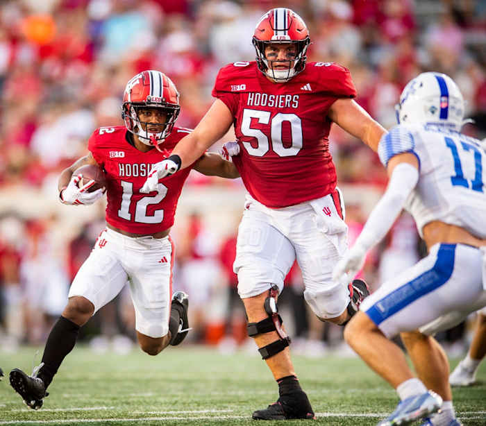 Indiana's Jaylin Lucas (12) runs behind Zach Carpenter (50) during the first half of the Indiana versus Indiana State football game at Memorial Stadium on Friday, Sept. 8, 2023.