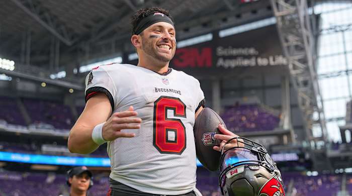 Baker Mayfield smiling and holding a football after winning his Buccaneers debut