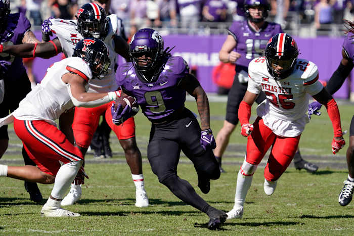 TCU Horned Frogs running back Emani Bailey (9) carries the ball against the Texas Tech Red Raiders during the second half of a game at Amon G. Carter Stadium.
