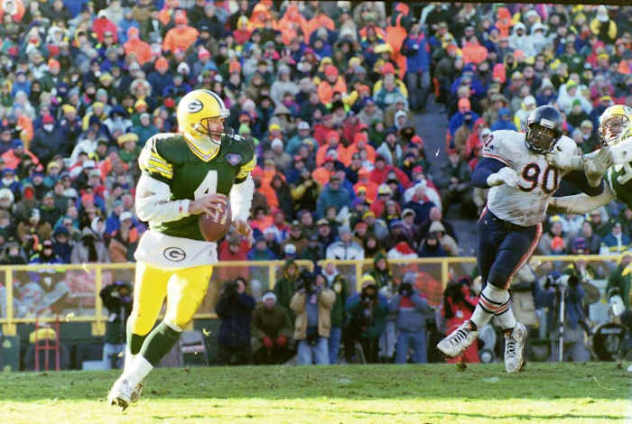 Green Bay Packers quarterback Brett Favre (4) looks to pass as Chicago Bears defensive back Alonzo Spellman (90) approaches. The Packers defeated the Chicago Bears 40-3 on Dec. 11, 1994, at Lambeau Field in Green Bay, Wis. Gpg Historical Packers Vs Bears 08182022 0012