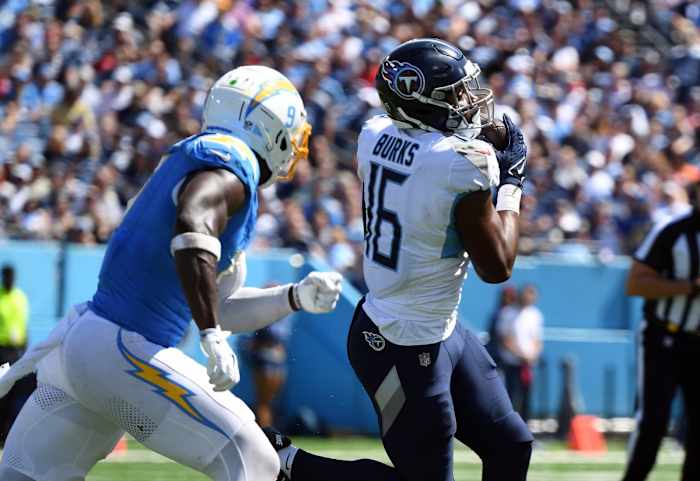 Titans wide receiver Treylon Burks (16) catches a pass against Los Angeles Chargers linebacker Kenneth Murray Jr. (9) during the first half at Nissan Stadium.