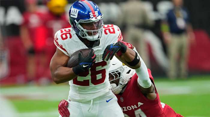 Arizona Cardinals safety Jalen Thompson (34) tackles New York Giants running back Saquon Barkley (26) during the first half of an NFL football game, Sunday, Sept. 17, 2023, in Glendale, Ariz. (AP Photo/Matt York)   