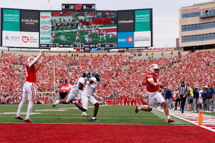 Sep 16, 2023; Madison, Wisconsin, USA; Wisconsin Badgers quarterback Tanner Mordecai (8) rushes for a touchdown during the third quarter against the Georgia Southern Eagles at Camp Randall Stadium. Mandatory Credit: Jeff Hanisch-USA TODAY Sports