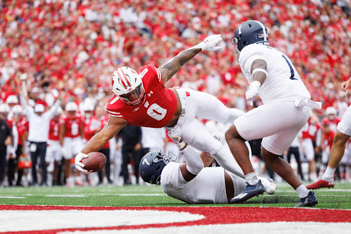 Sep 16, 2023; Madison, Wisconsin, USA; Wisconsin Badgers running back Braelon Allen (0) holds the football out to score a touchdown during the third quarter against the Georgia Southern Eagles at Camp Randall Stadium. Mandatory Credit: Jeff Hanisch-USA TODAY Sports