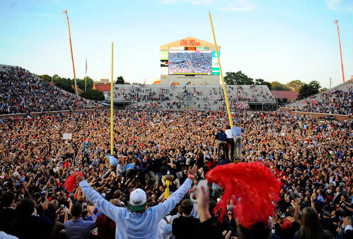Ole Miss fans celebrate their 2014 win over Alabama by storming the field at Vaught-Hemingway Stadium and tearing down the goal posts.