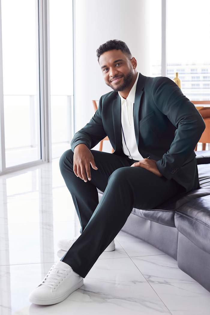 Tua Tagovailoa models a navy Perry Ellis suit.