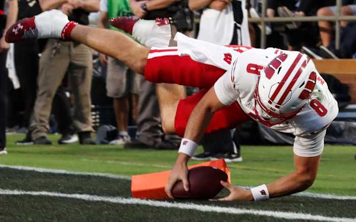 Wisconsin Badgers quarterback Tanner Mordecai (8) dives into the pylon for a touchdown during the NCAA football game against the Purdue Boilermakers, Friday, Sept. 22, 2023, at Ross-Ade Stadium in West Lafayette, Ind.