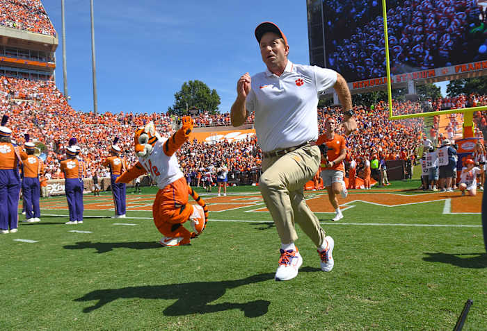 Clemson Tigers head coach Dabo Swinney runs on the field before a game.