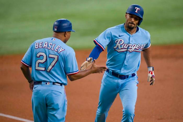 Sep 24, 2023; Arlington, Texas, USA; Texas Rangers second baseman Marcus Semien (2) rounds the bases past third base coach Tony Beasley (27) after Semien hits a lead off home run against the Seattle Mariners during the first inning at Globe Life Field. Mandatory Credit: Jerome Miron-USA TODAY Sports