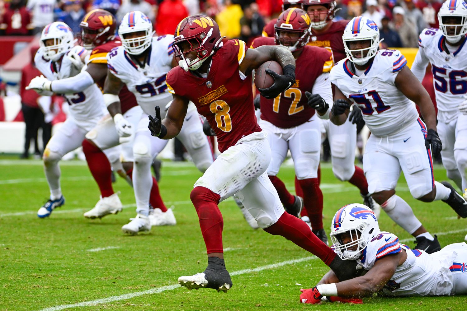 Washington Commanders running back Brian Robinson Jr. (8) carries the ball against the Buffalo Bills during the second half at FedExField.