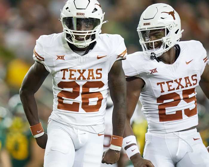 Texas running back Quintrevion Wisner (26) and Texas defensive back Jelani McDonald (25) celebrates a big tackle on the kick return in the third quarter of an NCAA college football game.