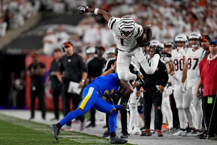 Sep 25, 2023; Cincinnati, Ohio, USA; Cincinnati Bengals wide receiver Ja'Marr Chase (1) leaps over Los Angeles Rams safety Russ Yeast (2) on a catch down the sideline in the fourth quarter of the NFL Week 3 game between the Cincinnati Bengals and the Los Angeles Rams at Paycor Stadium. Mandatory Credit: Sam Greene-USA TODAY Sports