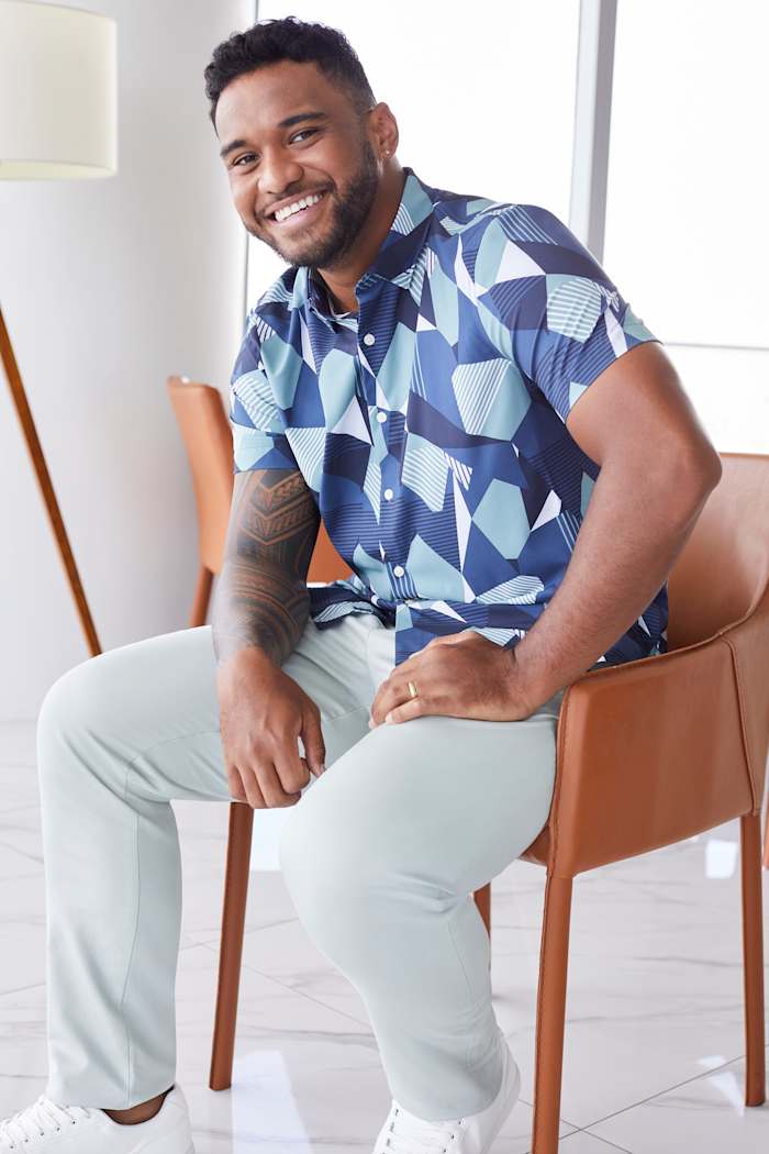 Tua Tagovailoa modeling a blue Perry Ellis shirt.