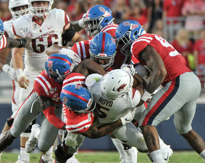 Ole Miss defenders tackle Arkansas running back Rakeem Boyd in 2019, a game that saw the Rebels emerge with a 31-17 home win.