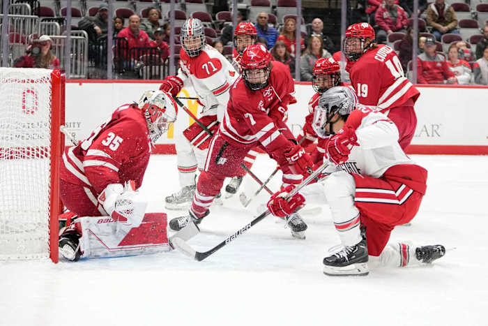 Oct 7, 2022; Columbus, Ohio, USA; Wisconsin Badgers goalie Jared Moe (35) stops a shot from Ohio State Buckeyes forward Joe Dunlap (21) during the NCAA men's hockey game at the Schottenstein Center. Mandatory Credit: Adam Cairns-The Columbus Dispatch Ncaa Hockey Wisconsin Vs Ohio State