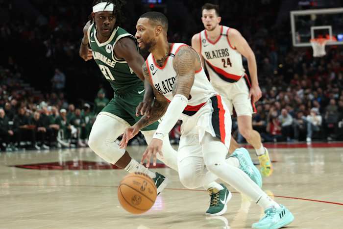 Portland Trail Blazers guard Damian Lillard (0) drives the lane against Milwaukee Bucks guard Jrue Holiday (21) i