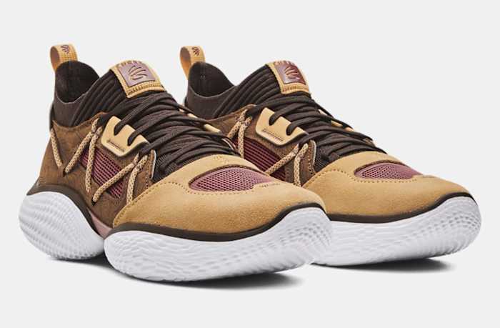 Side view of Stephen Curry's brown and white Under Armour sneakers.