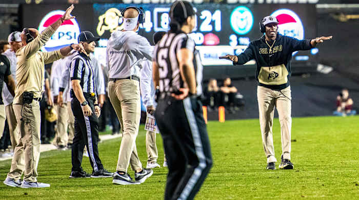 Colorado’s Deion Sanders communicates to his players from the sidelines.