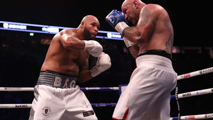 Frazer Clarke (left) in action against Kamil Sokolowski in the heavy-weight bout at the AO Arena, Manchester in November 12, 2022. The Polish professional boxer Sokolowski has been banned from all sport for a period of three years following Anti-Doping Rule Violations. IAN HODGSON/PA IMAGES VIA GETTY IMAGES.