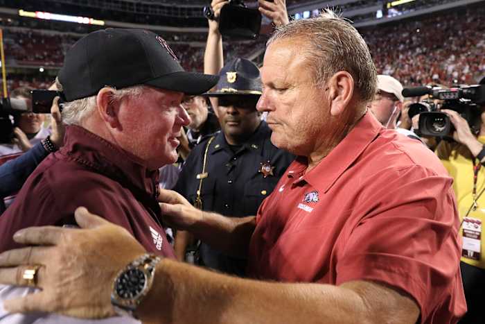 Texas A&M offensive coordinator Bobby Petrino embraces Arkansas head coach Sam Pittman while serving as head coach at Missouri State