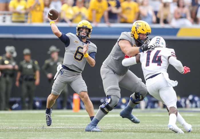 West Virginia Mountaineers quarterback Garrett Greene (6) throws a pass during the first quarter against the Duquesne Dukes at Mountaineer Field at Milan Puskar Stadium.