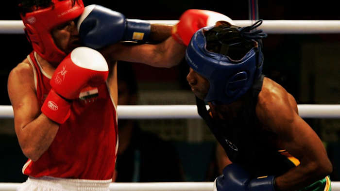 (L-R) Akhil Kumar of India and Bongani Mahlangu of South Africa exchange blows in their Bantamweight Quarterfinal Bout at the Melbourne 2006 Commonwealth Games in Australia. Mahlangu will defend his junior featherweight title when he meets Luthando Mbumbulwana in Midrand, SA this weekend. ROSS LAND/GETTY IMAGES.
