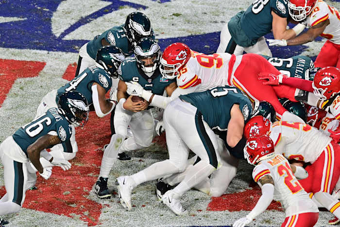 Kansas City Chiefs defensive tackle Chris Jones (95) tackles Philadelphia Eagles quarterback Jalen Hurts (1) on a quarterback sneak during the second quarter of Super Bowl LVII at State Farm Stadium.