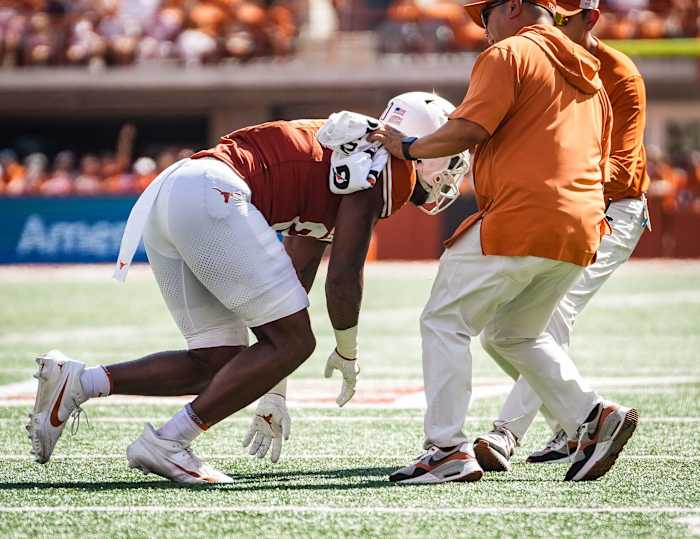 Texas tight end Ja'Tavion Sanders (0) is helped off the field by Texas staff in the first quarter of the Longhorns' game against the Kansas Jayhawks, Saturday, Sept. 30 at Darrell K Royal-Texas Memorial Stadium