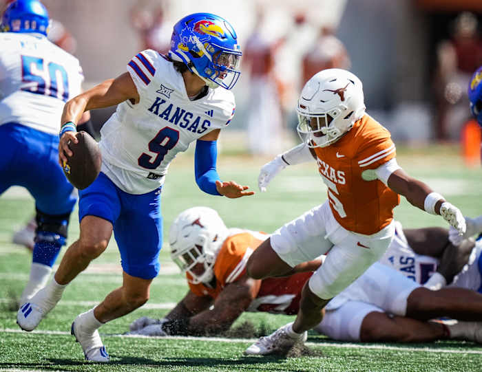 Texas defensive back Malik Muhammad (5) goes to tackle Kansas quarterback Jason Bean (9) in the first quarter of the Longhorns' game against the Kansas Jayhawks, Saturday, Sept. 30 at Darrell K Royal-Texas Memorial Stadium in Austin.