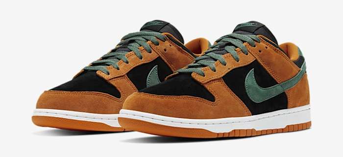 Side view of black, orange, and green Nike Dunk sneakers.
