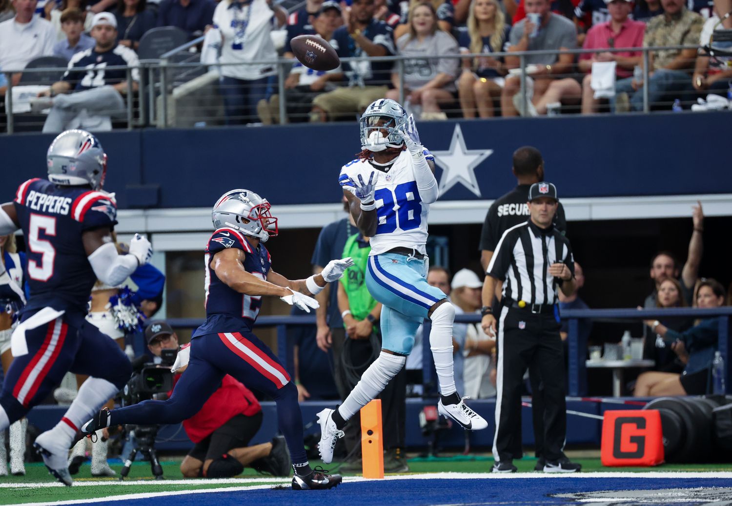 Oct 1, 2023; Arlington, Texas, USA; Dallas Cowboys wide receiver CeeDee Lamb (88) catches a touchdown pass over New England Patriots cornerback Myles Bryant (27) during the first quarter at AT&T Stadium. Mandatory Credit: Kevin Jairaj-USA TODAY Sports