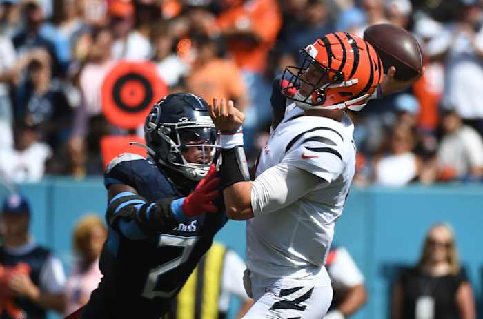 Bengals quarterback Joe Burrow (9) is hit by Tennessee Titans linebacker Azeez Al-Shaair (2) as he throws the ball during the first half at Nissan Stadium.