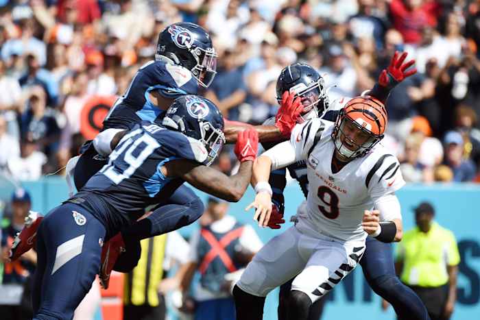 Cincinnati Bengals quarterback Joe Burrow (9) throws the ball ahead of pressure during the first half against the Tennessee Titans at Nissan Stadium.