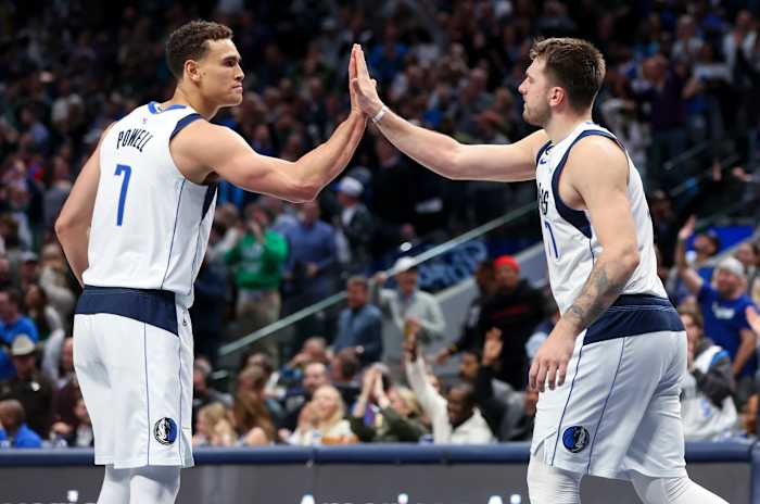 Dallas Mavs' Dwight Powell and Luka Doncic share a high five against the Los Angeles Clippers.
