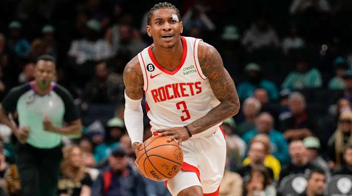 Kevin Porter Jr. holds the ball in both hands preparing to throw it