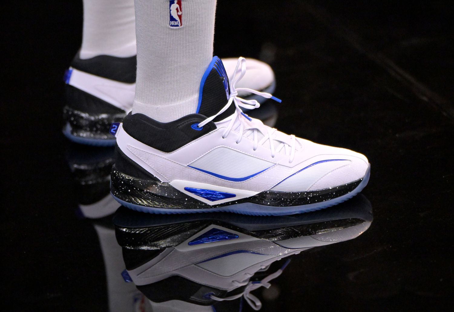Los Angeles Clippers forward Kawhi Leonard's white, black, and blue New Balance shoes.