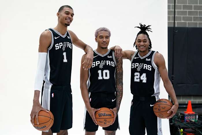 Oct 2, 2023; San Antonio, TX, USA; San Antonio Spurs center Victor Wembanyama (1) poses for photos with forwards guard Devin Vassell (24) and Jeremy Sochan (10) during media day in San Antonio.