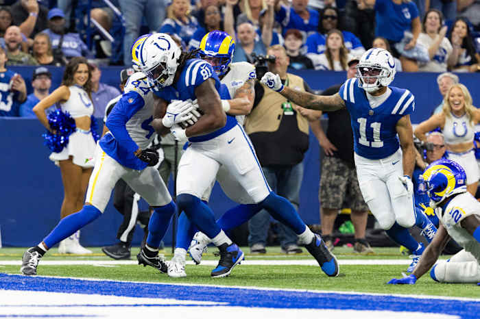 Oct 1, 2023; Indianapolis, Indiana, USA; Indianapolis Colts tight end Mo Alie-Cox (81) scores a touchdown while Los Angeles Rams linebacker Michael Hoecht (97) and cornerback Ahkello Witherspoon (44) defend in the second half at Lucas Oil Stadium. Mandatory Credit: Trevor Ruszkowski-USA TODAY Sports