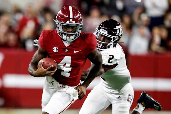 Alabama quarterback Jalen Milroe (No.4) avoids a tackle against Texas A&M defensive back Jacoby Matthews